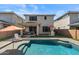Resort-style backyard with a sparkling pool, covered patio area, outdoor kitchen, and lush lawn at 22136 N 28Th Pl, Phoenix, AZ 85050