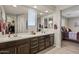 A bathroom with a double sink vanity and walk-in closet and bedroom view at 22136 N 28Th Pl, Phoenix, AZ 85050