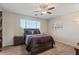 Cozy bedroom with a ceiling fan, natural lighting, and comfortable furnishings at 22136 N 28Th Pl, Phoenix, AZ 85050