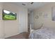 A bedroom featuring neutral walls, a plush bed, and a tv mounted to the wall at 22136 N 28Th Pl, Phoenix, AZ 85050