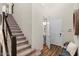 Inviting entryway featuring a staircase, coat closet and convenient powder room at 22136 N 28Th Pl, Phoenix, AZ 85050