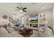 Inviting living room featuring a stylish ceiling fan and a modern built-in media center at 22136 N 28Th Pl, Phoenix, AZ 85050