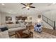 Comfortable living room with gray sectional, a ceiling fan, and view of the open floor plan at 22136 N 28Th Pl, Phoenix, AZ 85050