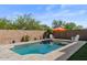 Inviting backyard pool with brick surround, mature landscaping, and relaxing lounge chairs with shade umbrella at 22136 N 28Th Pl, Phoenix, AZ 85050