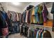 A walk-in closet filled with assorted clothing and items at 22136 N 28Th Pl, Phoenix, AZ 85050