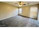 This bedroom is a spacious room with neutral-toned walls, plush carpeting, and dual windows for ample natural light at 22311 W Woodlands Ave, Buckeye, AZ 85326