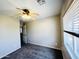 Bedroom with a ceiling fan, carpeted flooring, a window for natural light, and a standard closet at 22311 W Woodlands Ave, Buckeye, AZ 85326