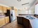 Kitchen with stainless steel refrigerator and dual basin sink with light fixtures at 22311 W Woodlands Ave, Buckeye, AZ 85326