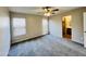 This main bedroom offers generous space, neutral walls, plush carpeting, and two windows for plenty of natural light at 22311 W Woodlands Ave, Buckeye, AZ 85326