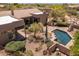 Aerial view of a home featuring a swimming pool, tile roof, desert landscaping, and an outdoor grill at 23760 N 80Th Way, Scottsdale, AZ 85255