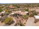 This aerial image features the property's desert landscape, and well manicured circular driveway at 23760 N 80Th Way, Scottsdale, AZ 85255