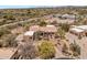 This aerial view showcases the property's desert landscaping and long driveway at 23760 N 80Th Way, Scottsdale, AZ 85255