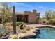Inviting backyard pool with lush desert landscaping and an outdoor kitchen area at 23760 N 80Th Way, Scottsdale, AZ 85255