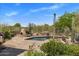 Backyard pool and patio area with desert landscaping, a fireplace, and an outdoor grill at 23760 N 80Th Way, Scottsdale, AZ 85255