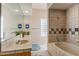 Well-lit bathroom with tile surround, modern vanity, and combination shower and tub at 23760 N 80Th Way, Scottsdale, AZ 85255