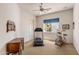 Bright bedroom featuring a treadmill, stationary bike, desk, and built-in shelving at 23760 N 80Th Way, Scottsdale, AZ 85255