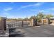 Community iron gate in a desert environment with blue skies and natural landscaping at 23760 N 80Th Way, Scottsdale, AZ 85255