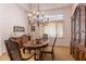 Traditional dining room with wooden furniture, a chandelier, and a large window at 23760 N 80Th Way, Scottsdale, AZ 85255