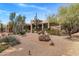 Stunning desert home showcasing natural landscaping with various cacti and trees at 23760 N 80Th Way, Scottsdale, AZ 85255