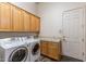 Laundry room features a washer, dryer, built-in cabinets and sink at 23760 N 80Th Way, Scottsdale, AZ 85255