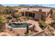Backyard pool area surrounded by desert landscaping and a brick-laid patio with mountain views in the background at 23760 N 80Th Way, Scottsdale, AZ 85255