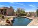 In-ground pool with brick trim and desert landscaping, with an outdoor grill and fireplace at 23760 N 80Th Way, Scottsdale, AZ 85255