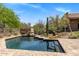 In-ground pool with brick trim and stairs, surrounded by desert landscaping and greenery on a sunny day at 23760 N 80Th Way, Scottsdale, AZ 85255