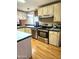 Well-lit kitchen showcasing stainless steel appliances and ample counter space at 2400 E Baseline Ave # 201, Apache Junction, AZ 85119
