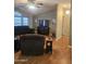 Inviting living room boasts vaulted ceiling, updated flooring, and cozy, plush furnishings at 2400 E Baseline Ave # 201, Apache Junction, AZ 85119