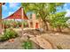 Serene backyard showcasing a shade sail, mature tree, and stone pathway leading to a charming outdoor space at 2546 N 9Th St, Phoenix, AZ 85006