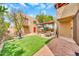 Charming backyard featuring artificial grass, a basketball hoop, and covered patio area with unique brick and gravel design at 2546 N 9Th St, Phoenix, AZ 85006