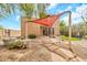 Beautiful backyard with a patio, a red sunshade, lush greenery, and a water fountain at 2546 N 9Th St, Phoenix, AZ 85006
