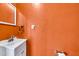 Orange bathroom featuring a sink and mirror at 2546 N 9Th St, Phoenix, AZ 85006