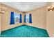 Bedroom featuring a window with blue curtains and turquoise carpet at 2546 N 9Th St, Phoenix, AZ 85006