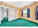 Bedroom featuring a window with blue curtains and green carpet at 2546 N 9Th St, Phoenix, AZ 85006