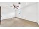 Spacious bedroom with neutral carpet, white walls, ceiling fan, and a window allowing natural light at 2546 N 9Th St, Phoenix, AZ 85006