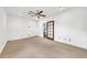 Spacious bedroom with neutral carpet, white walls, ceiling fan, and a door leading to additional rooms at 2546 N 9Th St, Phoenix, AZ 85006