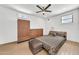 Bright main bedroom with plank floors, ceiling fan, ensuite bathroom, and built-in storage at 2546 N 9Th St, Phoenix, AZ 85006