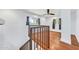 Upper staircase landing with wood floors, natural light, and view of downstairs entry at 2546 N 9Th St, Phoenix, AZ 85006
