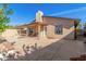 Backyard featuring a covered patio, mature trees, and a stucco wall for added privacy at 2635 W Hearn Rd, Phoenix, AZ 85023