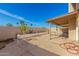 Large backyard features a covered patio, desert landscaping, and a block wall for privacy at 2635 W Hearn Rd, Phoenix, AZ 85023