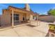 Backyard features a covered patio, mature trees, and a stucco wall for added privacy at 2635 W Hearn Rd, Phoenix, AZ 85023