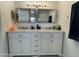 Bright bathroom features a double vanity, marble countertop, and modern fixtures at 2635 W Hearn Rd, Phoenix, AZ 85023