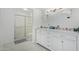Bright bathroom with a white double vanity, marble countertop, and a glass-enclosed shower at 2635 W Hearn Rd, Phoenix, AZ 85023