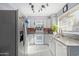 Well-lit kitchen featuring modern appliances, sleek countertops, and ample cabinet space for storage at 2635 W Hearn Rd, Phoenix, AZ 85023