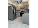 Spacious kitchen features stainless steel refrigerator and grey cabinets at 2635 W Hearn Rd, Phoenix, AZ 85023