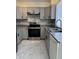 Well-lit kitchen features grey cabinets, stainless steel appliances, and marble countertops at 2635 W Hearn Rd, Phoenix, AZ 85023