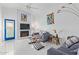 Bright living room featuring vaulted ceilings, cozy fireplace, modern decor, and ample natural light at 2635 W Hearn Rd, Phoenix, AZ 85023