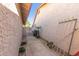 Narrow side yard with a walkway leading to a wooden gate, showcasing the property's exterior at 2635 W Hearn Rd, Phoenix, AZ 85023