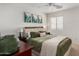 Comfortable bedroom with a plush bed, soft lighting, and tasteful nature-themed artwork at 27420 N 63Rd Dr, Phoenix, AZ 85083